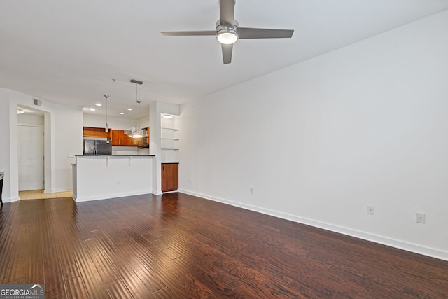 unfurnished living room featuring a ceiling fan, visible vents, wood finished floors, baseboards, and recessed lighting