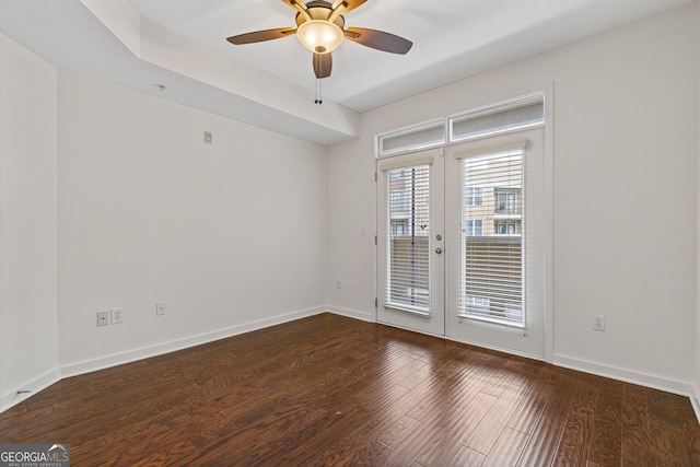 unfurnished room with french doors, baseboards, wood finished floors, and a ceiling fan