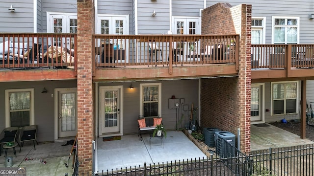 back of property featuring central air condition unit, a patio, and fence