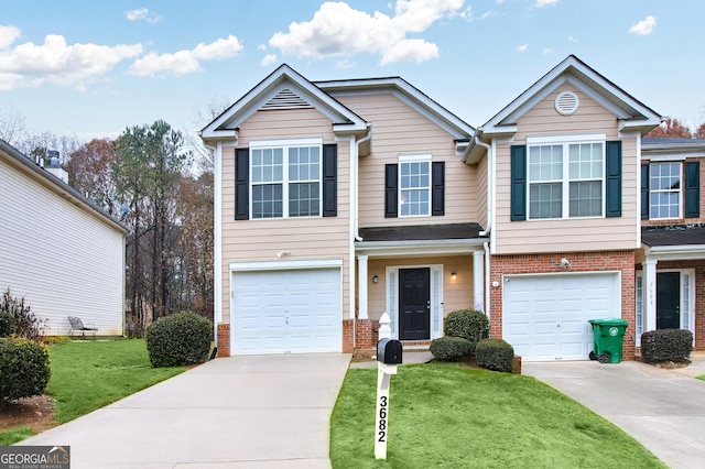 view of front of property featuring a front lawn, an attached garage, brick siding, and driveway