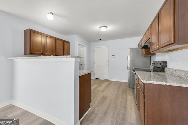 kitchen with baseboards, light wood-type flooring, stainless steel appliances, under cabinet range hood, and brown cabinets