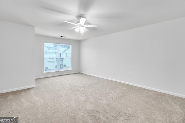 empty room featuring visible vents, baseboards, carpet, and ceiling fan