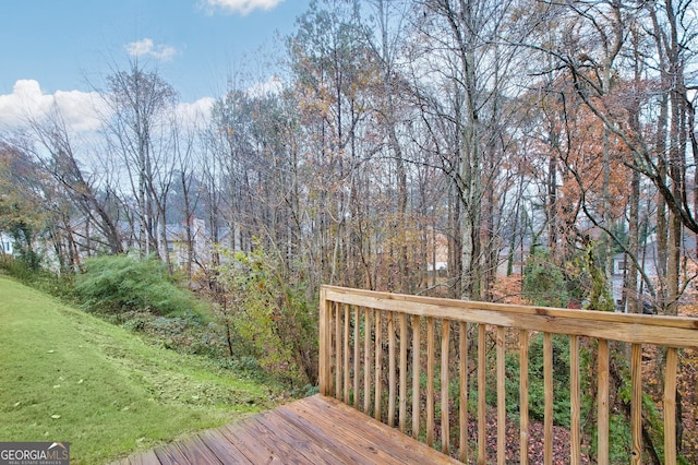 wooden terrace featuring a yard