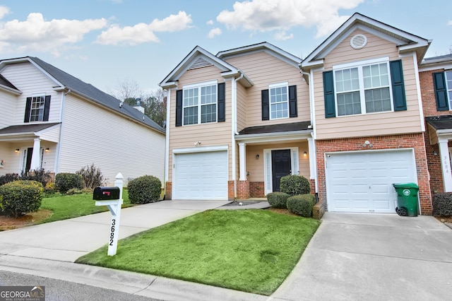 traditional home with brick siding, driveway, an attached garage, and a front yard