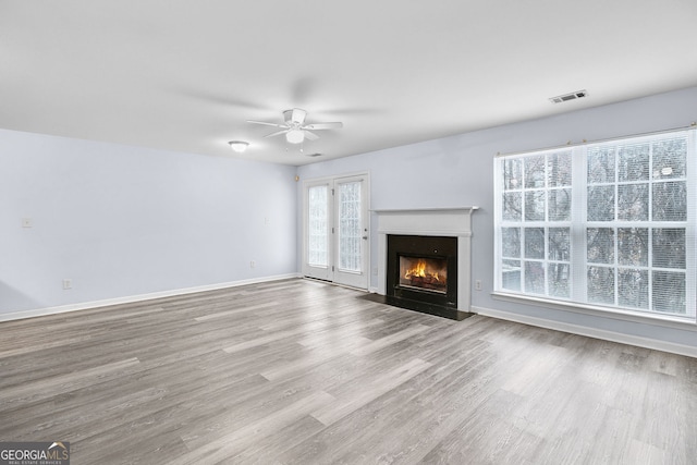 3682 Harvest Dr, Decatur, GA 30034 - unfurnished living room featuring a ceiling fan, wood finished floors, a fireplace with flush hearth, and baseboards