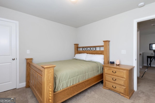 bedroom featuring light carpet