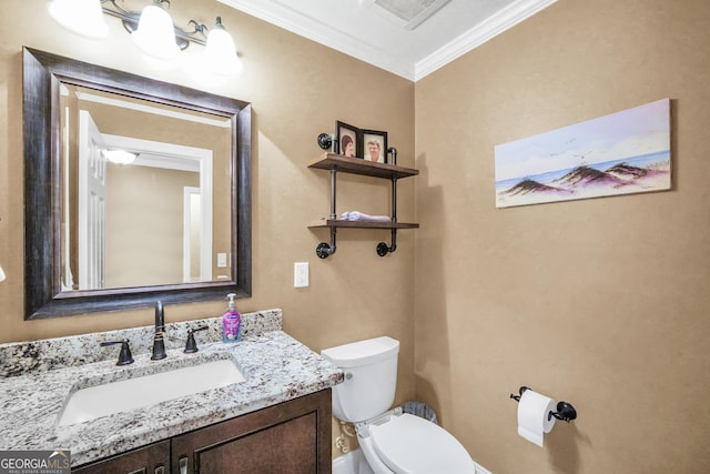 bathroom featuring visible vents, toilet, ornamental molding, and vanity