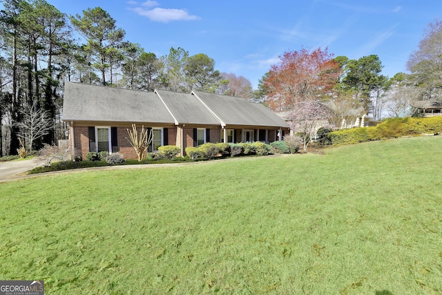 ranch-style house with brick siding and a front lawn