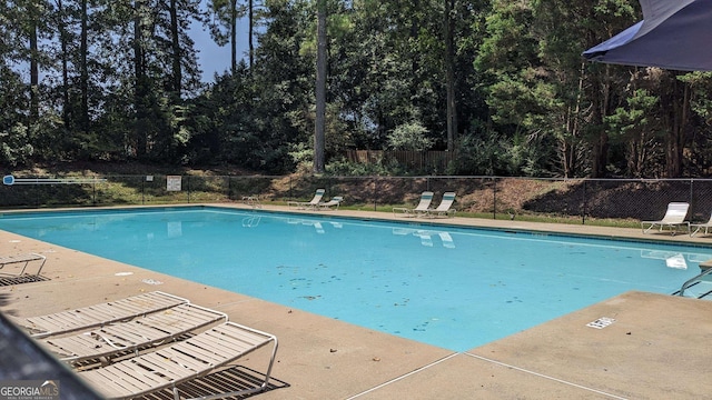 community pool featuring a patio area and fence