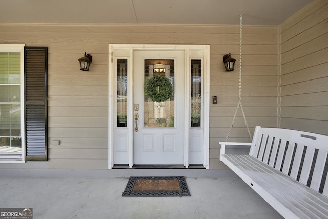 view of exterior entry featuring a porch