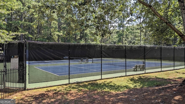 view of tennis court with fence