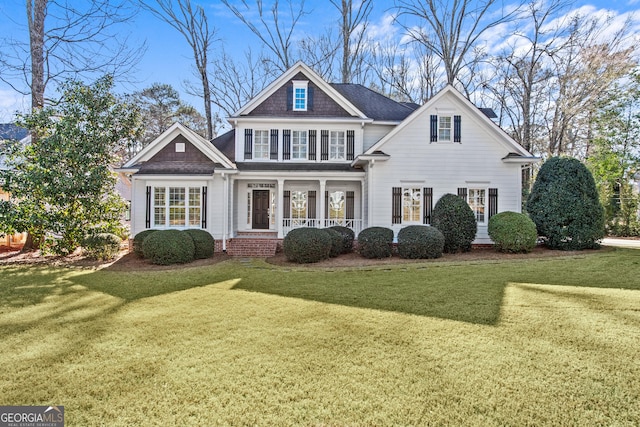 view of front facade with a porch and a front lawn