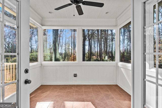 unfurnished sunroom with a wealth of natural light and ceiling fan