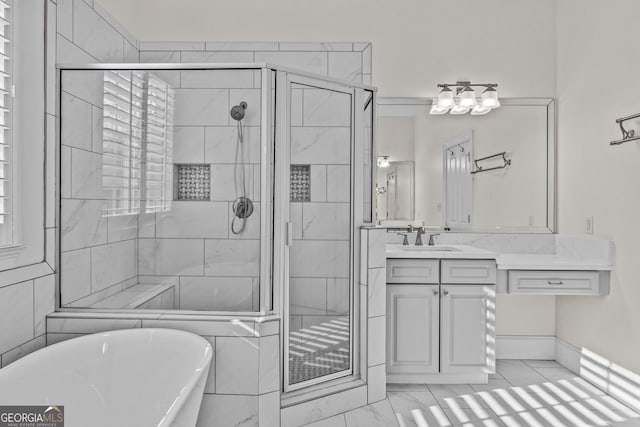 bathroom with vanity, a stall shower, marble finish floor, and a freestanding bath