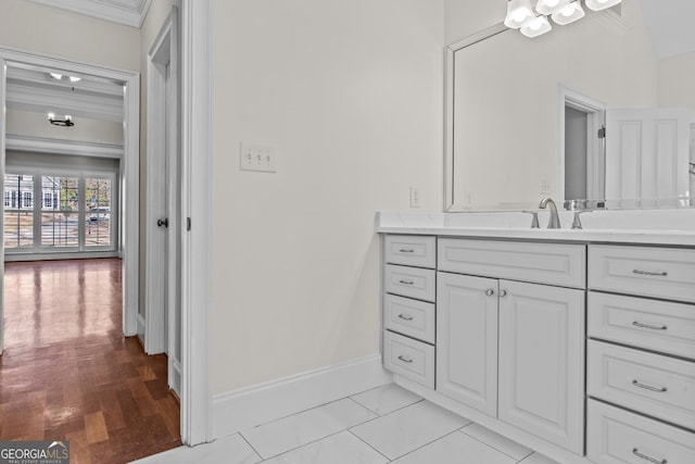 bathroom featuring baseboards, wood finished floors, and vanity