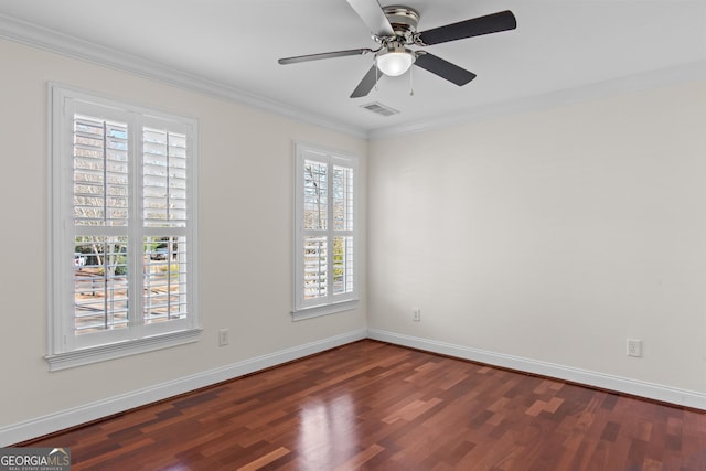 spare room featuring visible vents, baseboards, dark wood finished floors, and ornamental molding