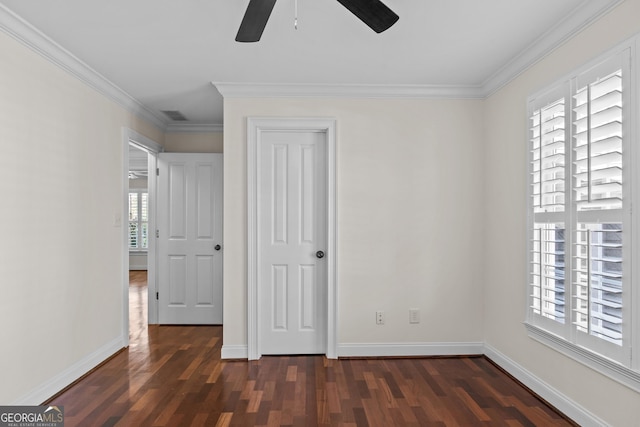 unfurnished bedroom with dark wood-style floors, visible vents, and ornamental molding