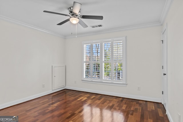 unfurnished room featuring crown molding, wood finished floors, visible vents, and baseboards