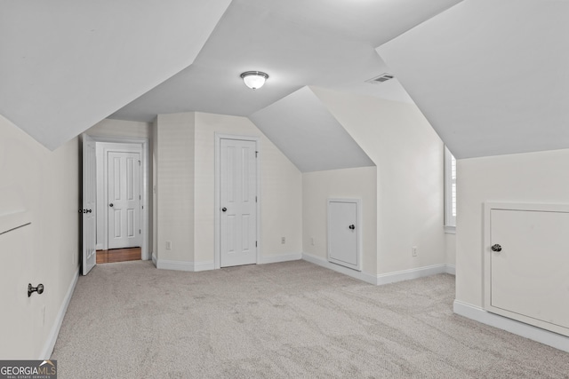 additional living space featuring lofted ceiling, carpet, visible vents, and baseboards