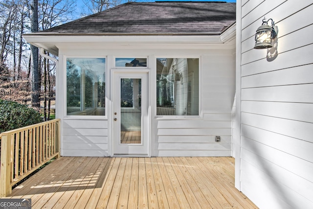 wooden deck with a sunroom