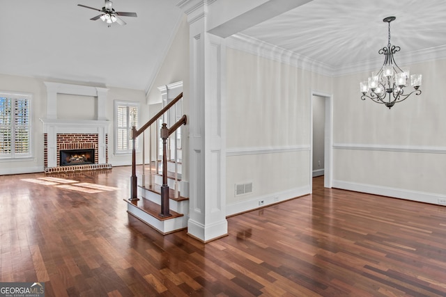interior space featuring stairway, wood finished floors, visible vents, a fireplace, and crown molding