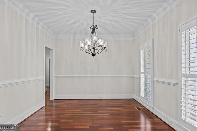 unfurnished dining area featuring visible vents, crown molding, baseboards, an inviting chandelier, and wood finished floors