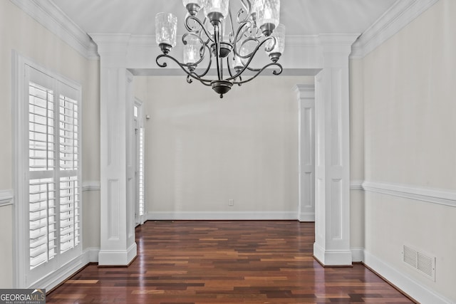 unfurnished dining area with visible vents, crown molding, and decorative columns