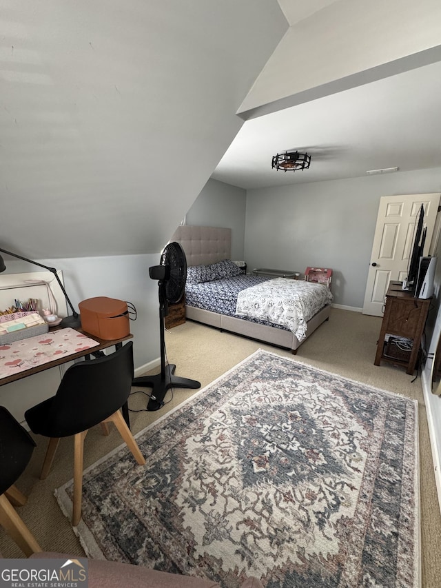 carpeted bedroom with baseboards and vaulted ceiling