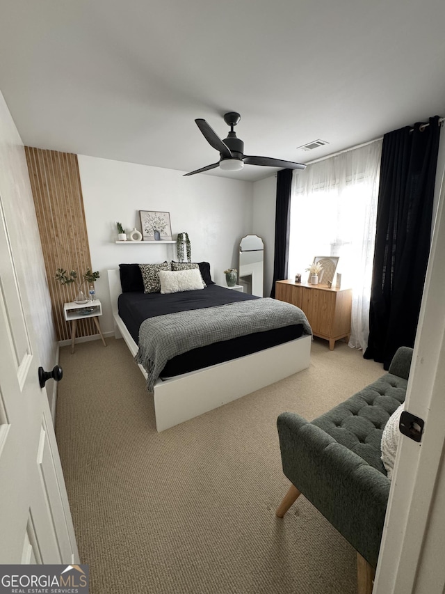 bedroom with visible vents, carpet, and a ceiling fan