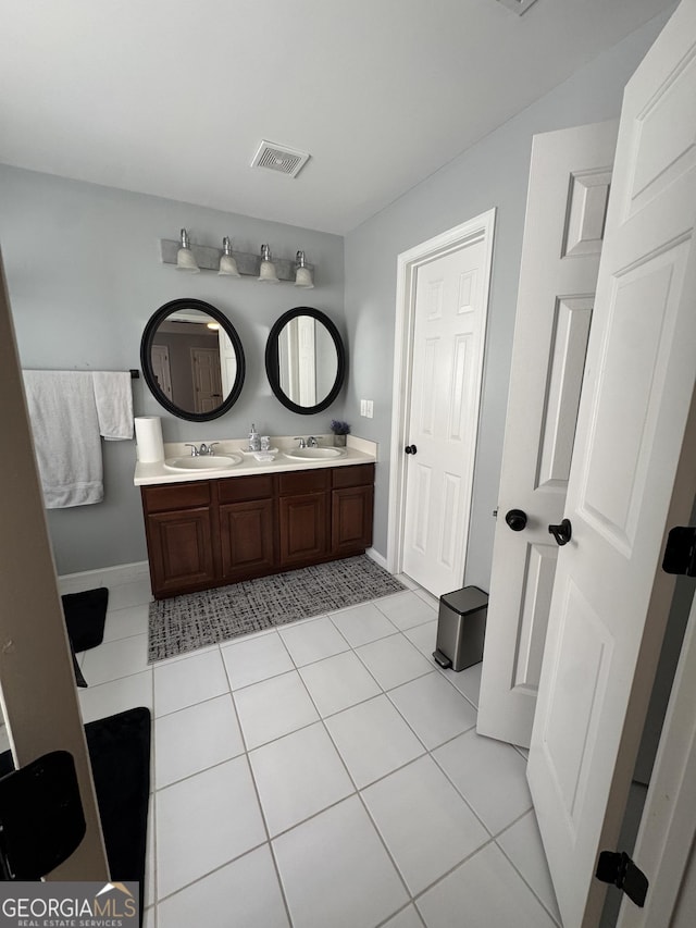 full bathroom with tile patterned flooring, visible vents, and a sink