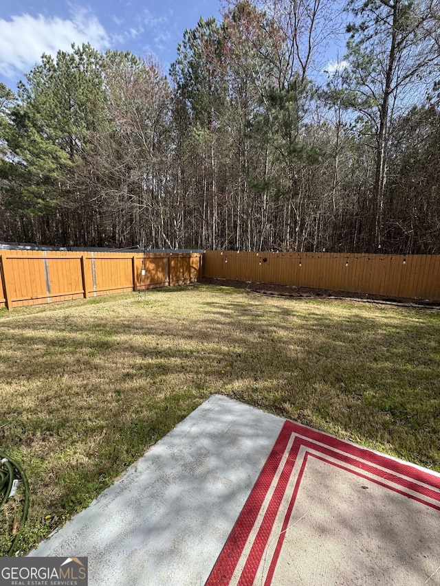 view of yard with a patio and fence