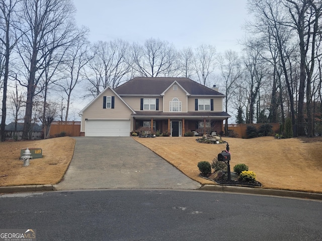 view of front of house with fence, driveway, and a chimney