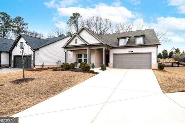 view of front of home with an attached garage, fence, board and batten siding, and driveway