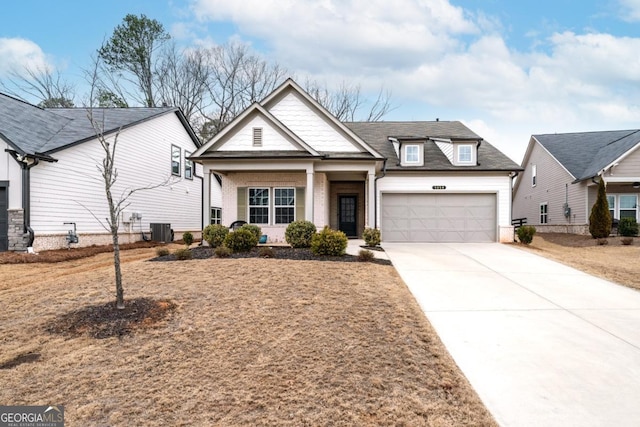 view of front of home featuring a garage, central AC unit, and driveway