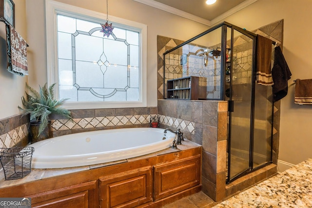 bathroom featuring crown molding, a bath, a healthy amount of sunlight, and a stall shower