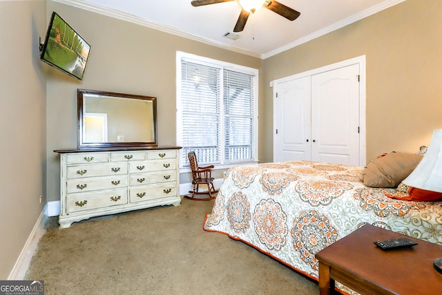 bedroom featuring visible vents, ornamental molding, a closet, carpet floors, and baseboards