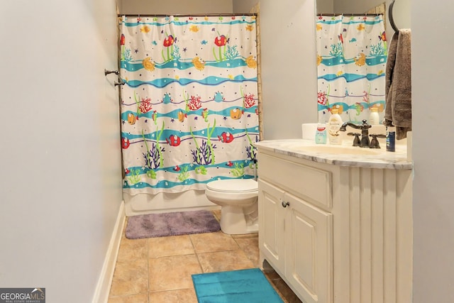 bathroom with tile patterned flooring, toilet, vanity, and baseboards