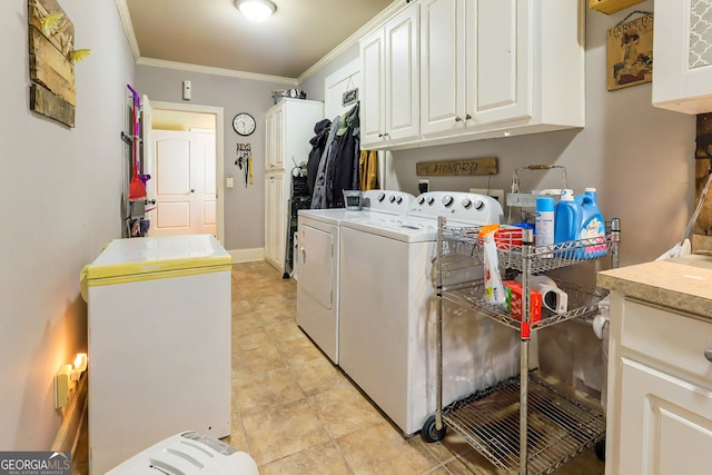 clothes washing area with baseboards, cabinet space, washing machine and dryer, and ornamental molding