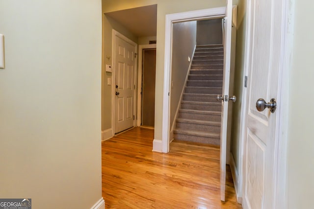 stairway featuring baseboards and wood finished floors