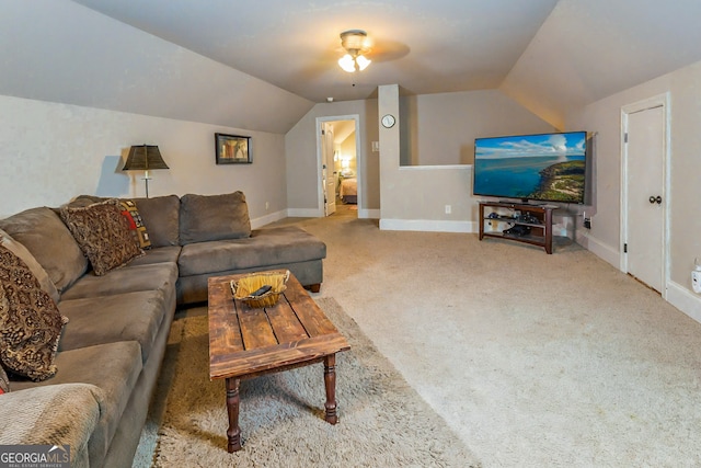 carpeted living room featuring baseboards and lofted ceiling