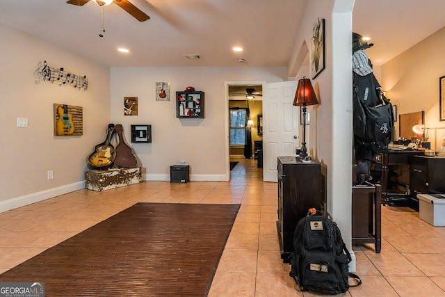 interior space with light tile patterned floors, visible vents, baseboards, and ceiling fan