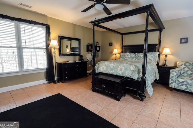 bedroom featuring light tile patterned floors, visible vents, and baseboards