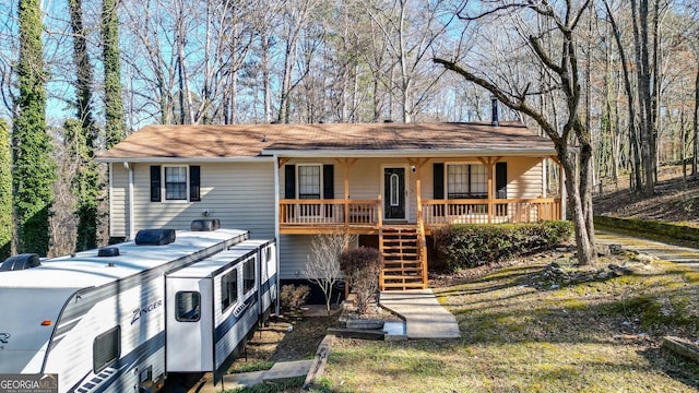 view of front of home with stairway and a porch