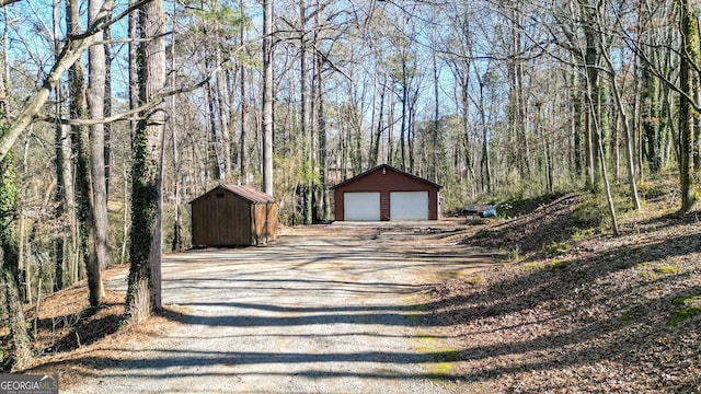 exterior space featuring a view of trees and dirt driveway