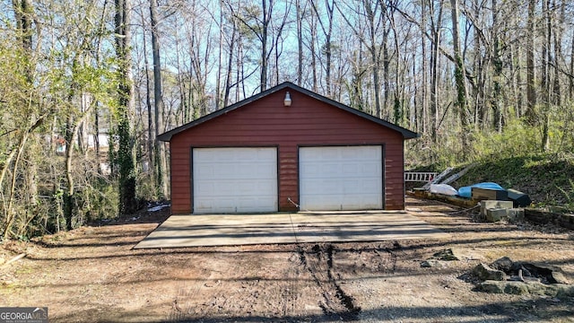 detached garage with a forest view