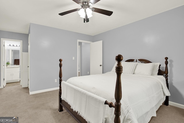 bedroom with baseboards, light carpet, ceiling fan, and ensuite bathroom