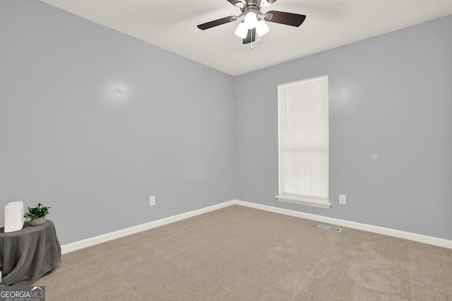 unfurnished room with visible vents, ceiling fan, baseboards, and carpet floors