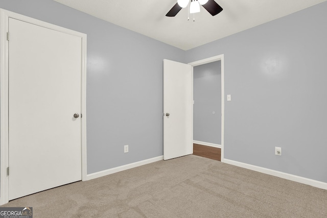 unfurnished bedroom featuring baseboards, carpet floors, and a ceiling fan