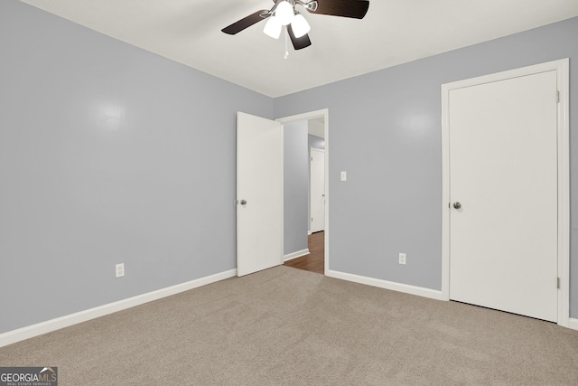 unfurnished bedroom with ceiling fan, baseboards, and carpet floors