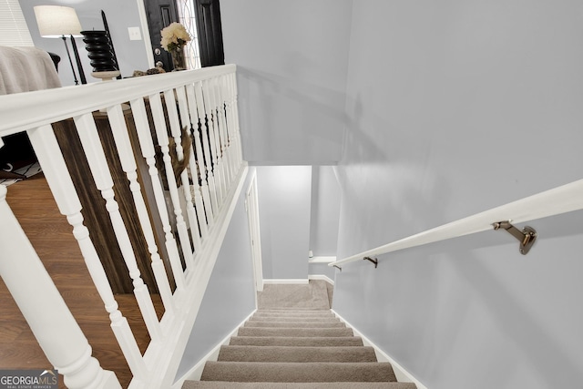 staircase featuring baseboards